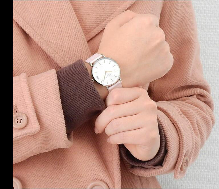 Coach Perry white dial watch worn on wrist with pink leather strap