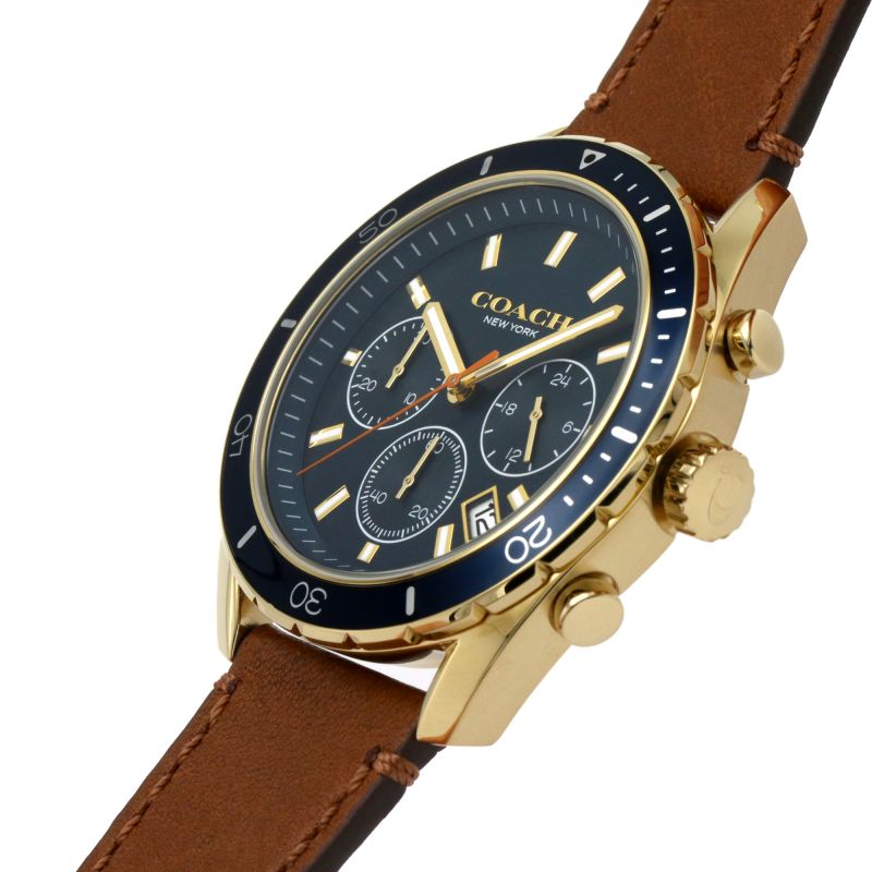 Coach Preston chronograph watch worn on wrist showing navy dial and gold-tone case