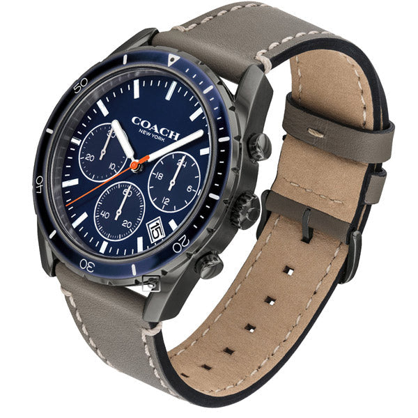 Coach Thompson watch shown at angle displaying blue dial and tan leather strap detail