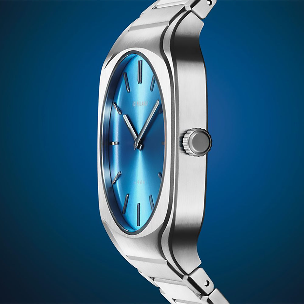 D1 Milano Square Maldives men's watch with sea blue dial, angled view on blue background