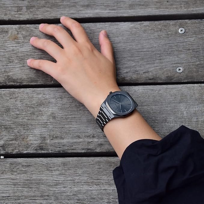 D1 Milano UTBJ22 grey dial watch worn on wrist against wooden background