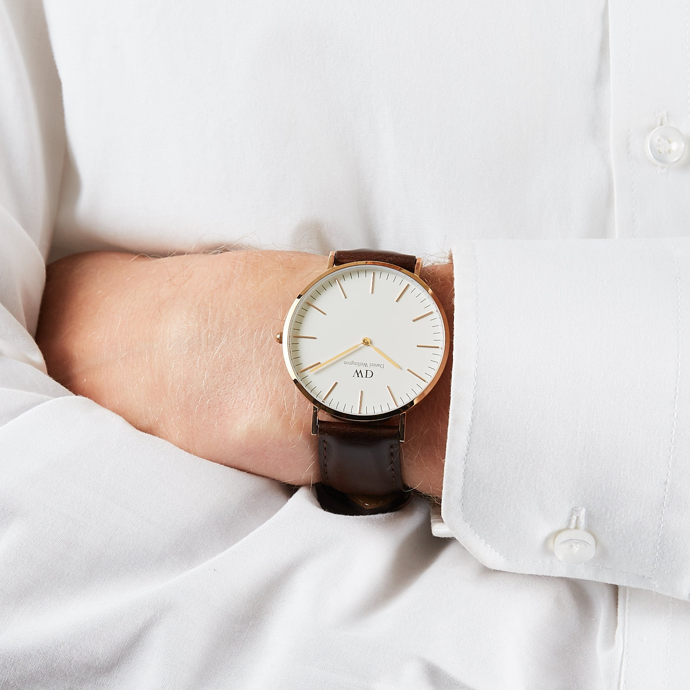 Daniel Wellington Classic Bristol 40mm gold watch worn on wrist with white shirt