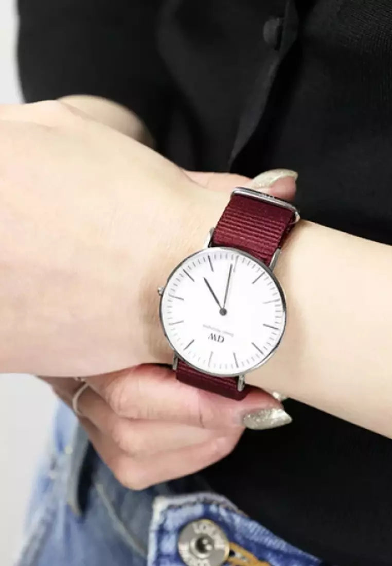 Daniel Wellington Classic watch with red nylon strap worn on wrist