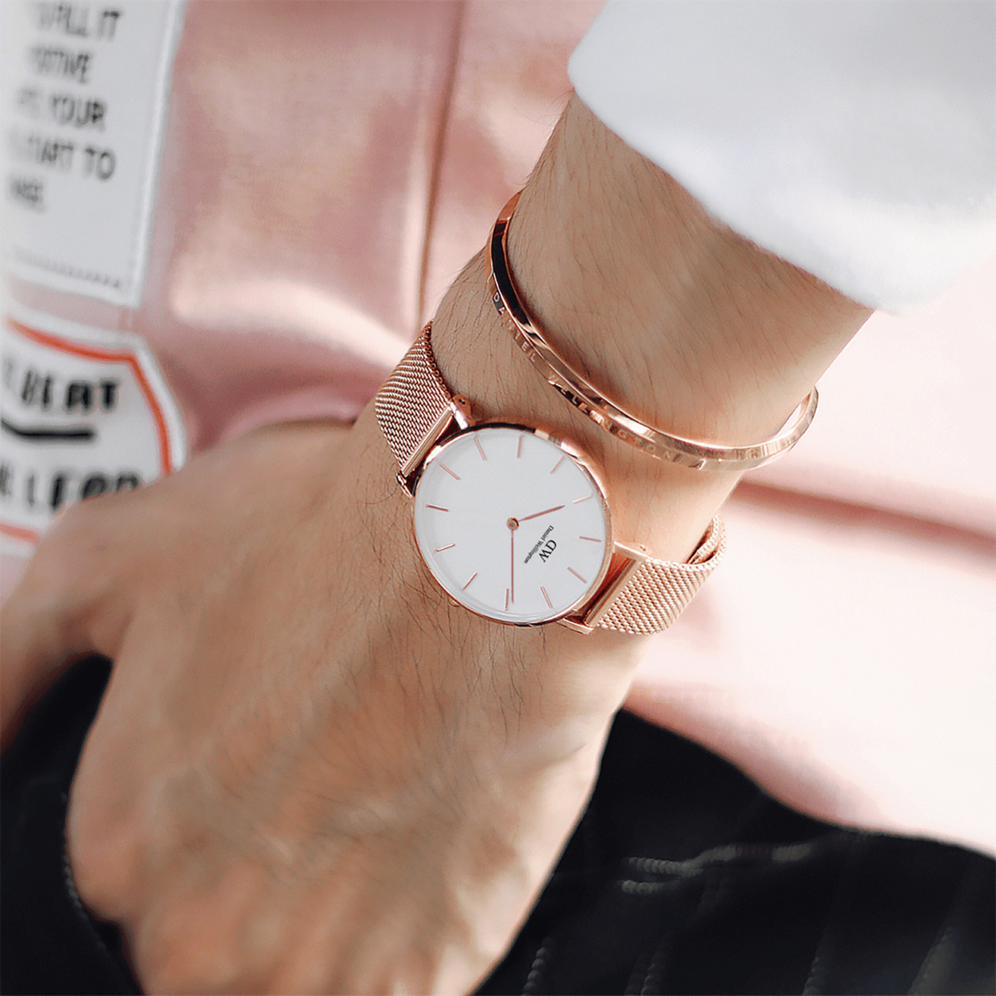 Daniel Wellington Classic rose gold cuff stacked on wrist with rose gold watch