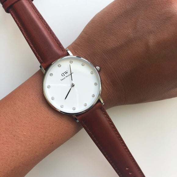 Daniel Wellington Classy St Mawes watch worn on wrist with white dial and brown leather strap