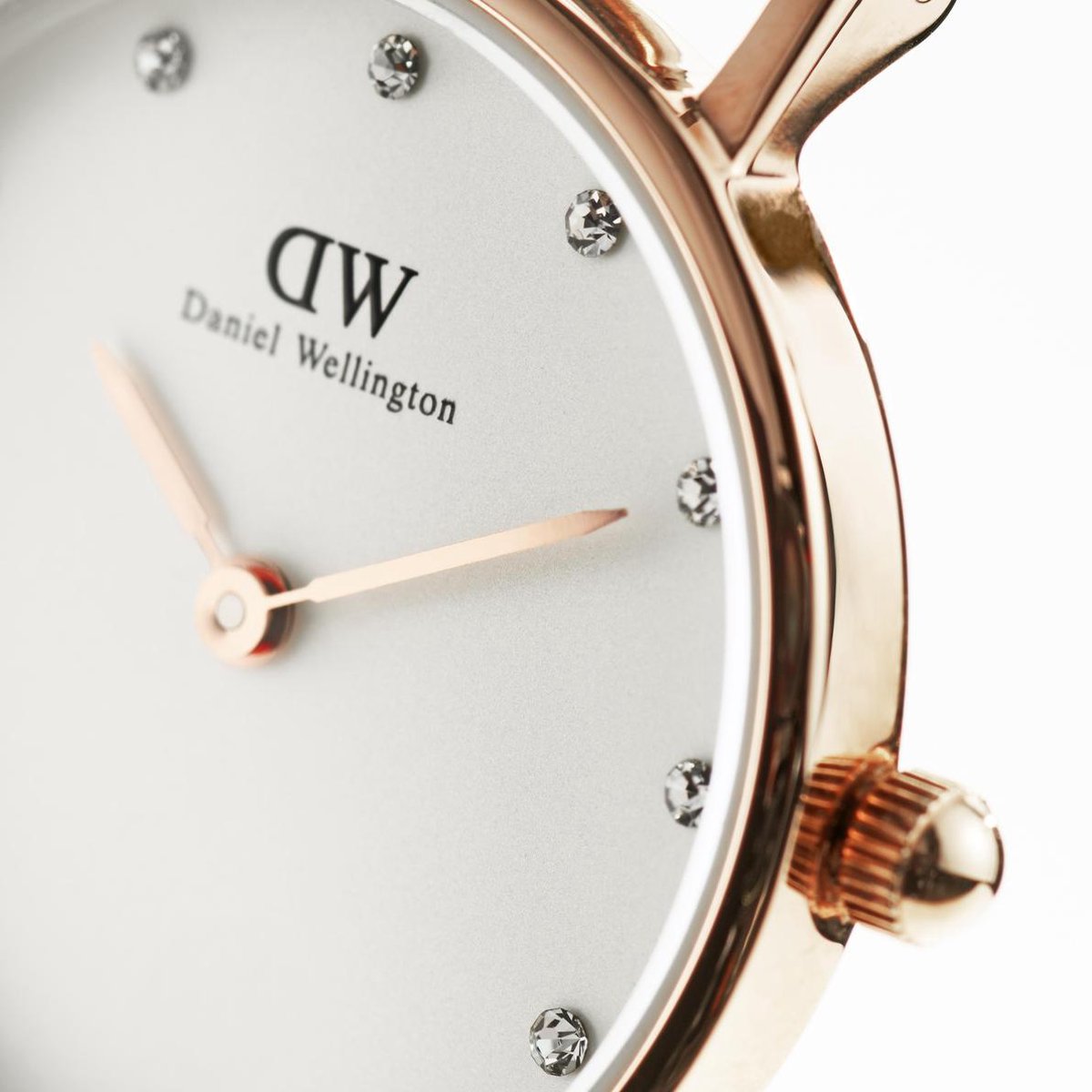 Close-up of white dial with diamond hour markers and rose gold hands