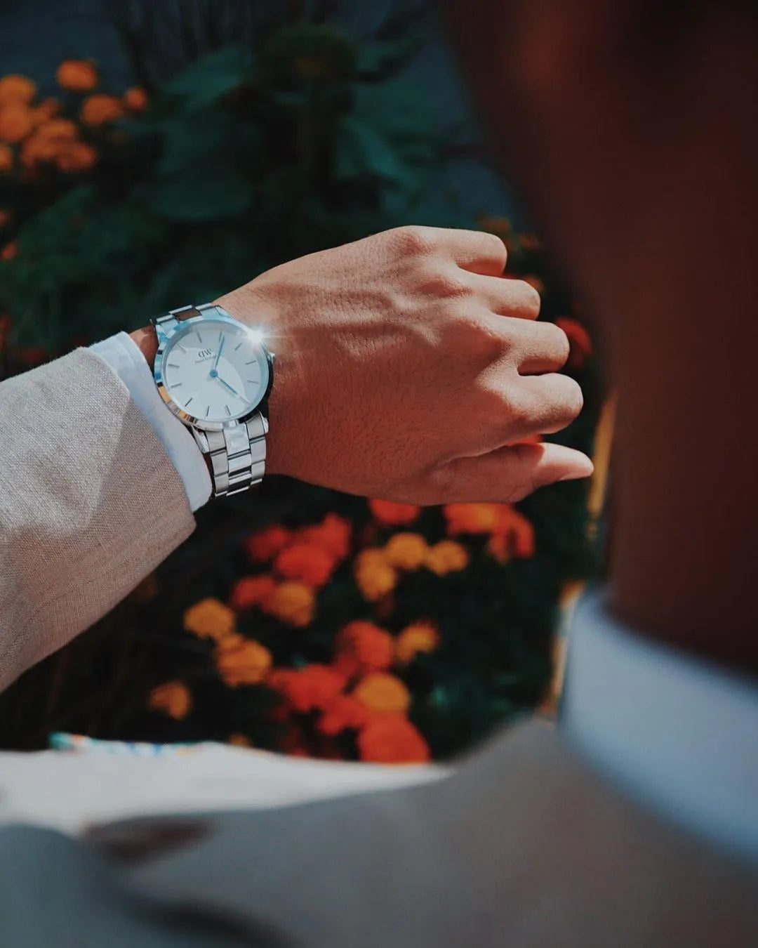Iconic Link 28mm silver watch worn on wrist with white dial visible