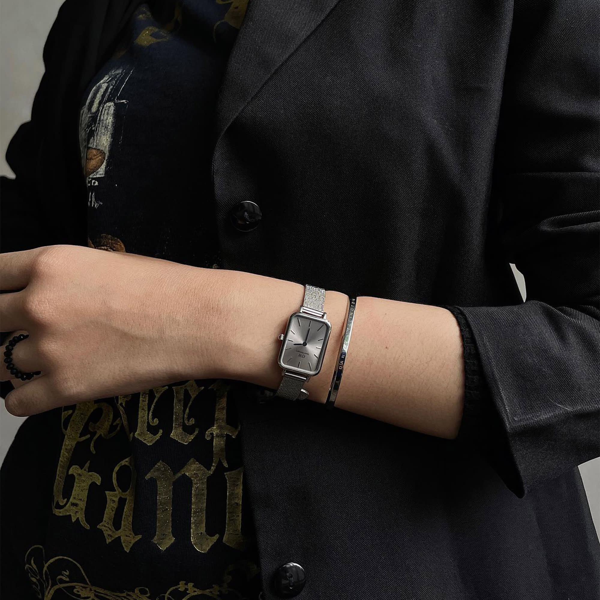 Daniel Wellington Quadro watch worn on wrist with silver mesh strap