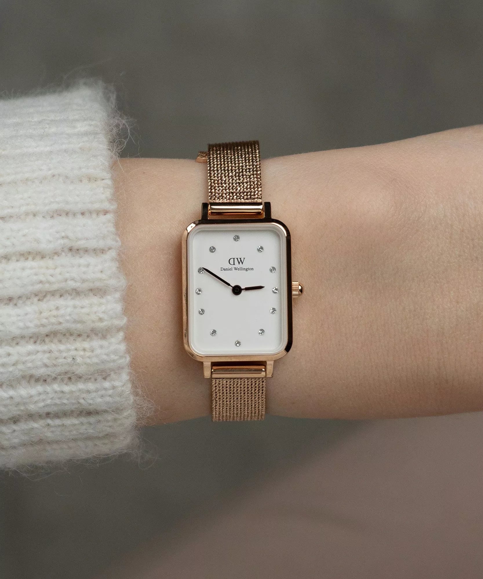 Daniel Wellington Quadro Lumine rose gold watch worn on wrist with rose gold mesh strap