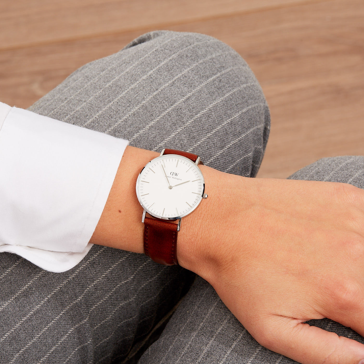 Daniel Wellington St Mawes 36mm watch worn on wrist with white dial and brown leather strap