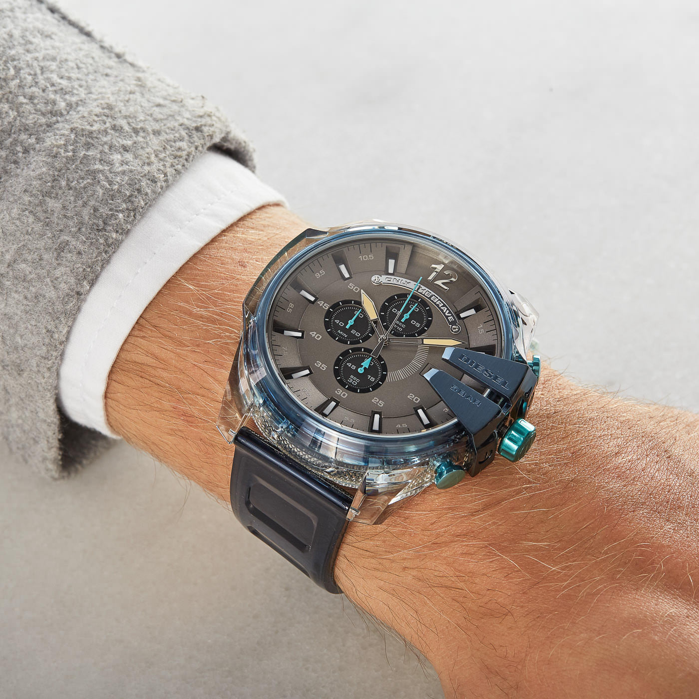 Diesel Mega Chief DZ4487 worn on wrist with gray sweater and white shirt cuff