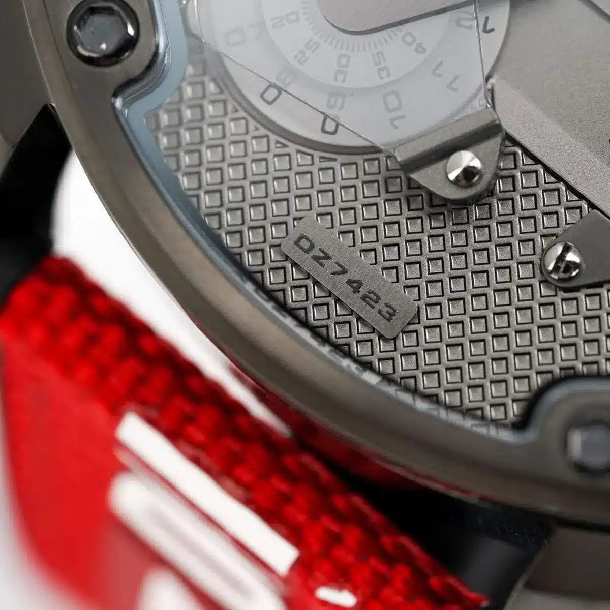 Close-up detail of Diesel chronograph dial showing gray texture and red accents