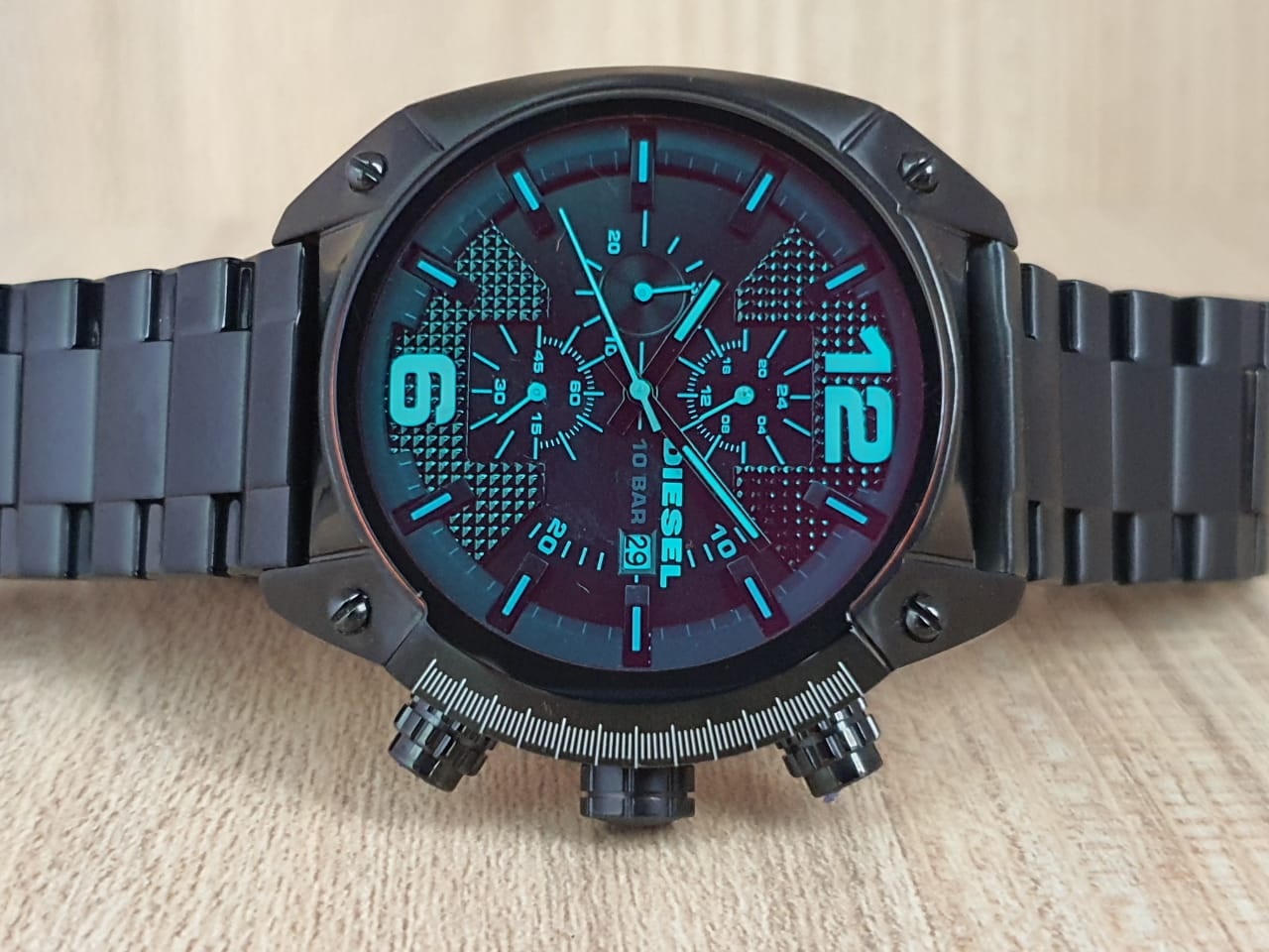 Diesel Overflow chronograph watch with black dial, cyan blue accents, and black ion-plated bracelet