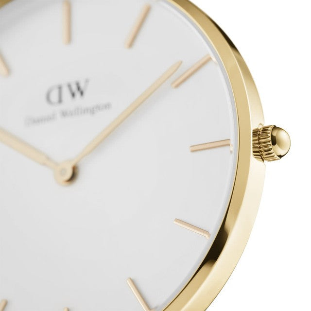Close-up of white dial with gold markers, hands, and DW branding on gold-tone case