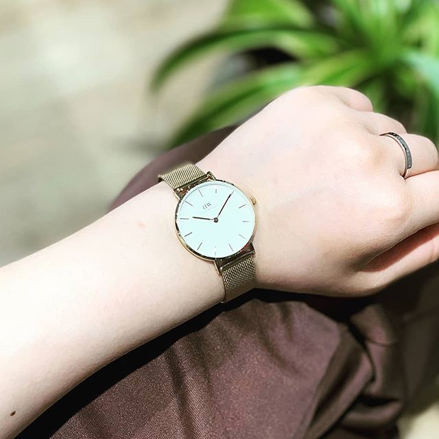 Gold-tone 32mm watch worn on wrist with gold mesh strap
