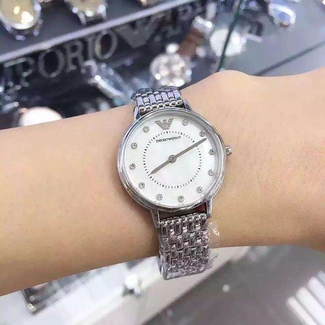 Emporio Armani AR11113 watch worn on wrist showing silver sunray dial and two-tone bracelet