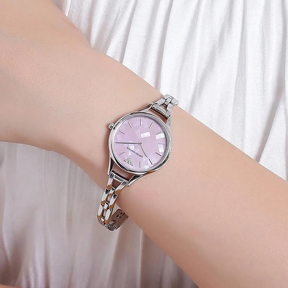 Emporio Armani Aurora watch on wrist with pink dial and silver steel bracelet