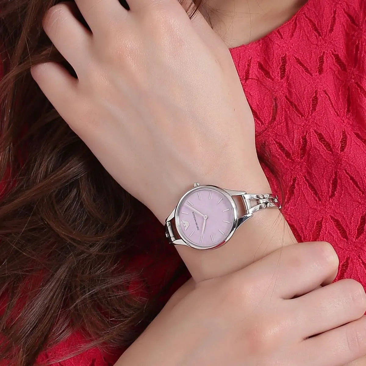 Emporio Armani Aurora watch worn on wrist showing pink mother-of-pearl dial