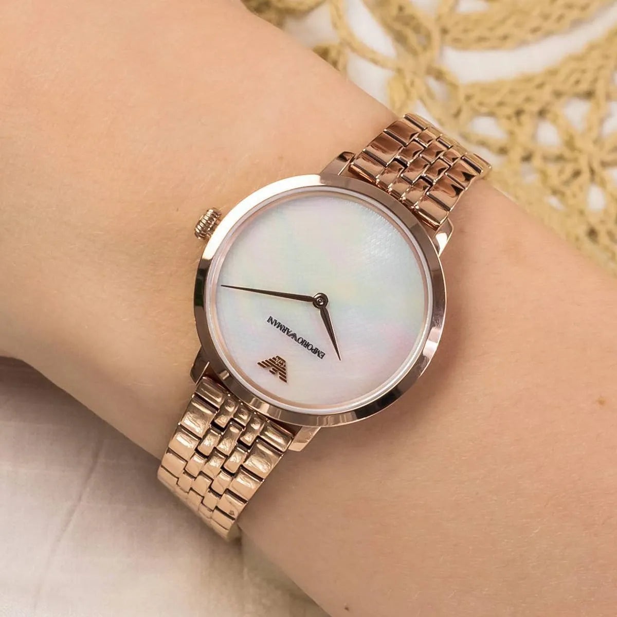 Emporio Armani AR11158 watch on wrist with rose gold bracelet and minimalist white dial