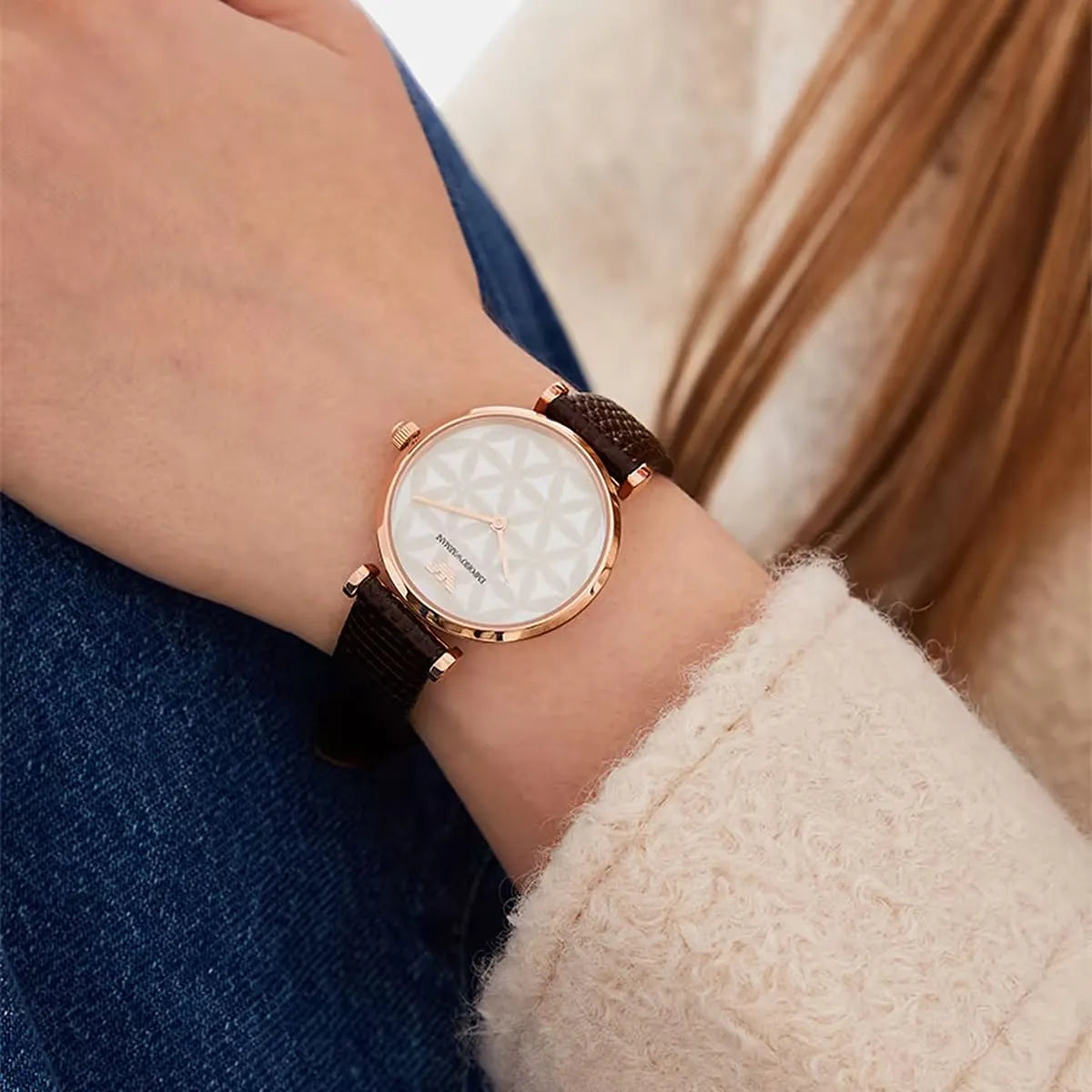 AR1990 women's watch on wrist showing rose gold case, white dial and brown leather strap styling