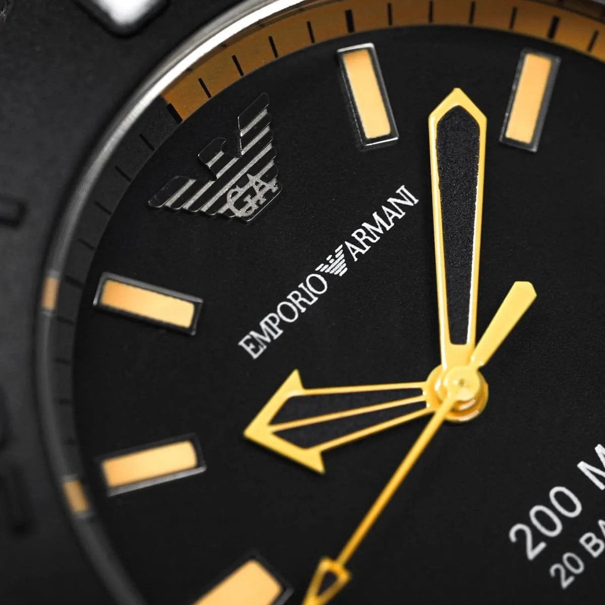 Close-up of AR5969 black dial with orange hour markers, yellow hands, and Emporio Armani branding