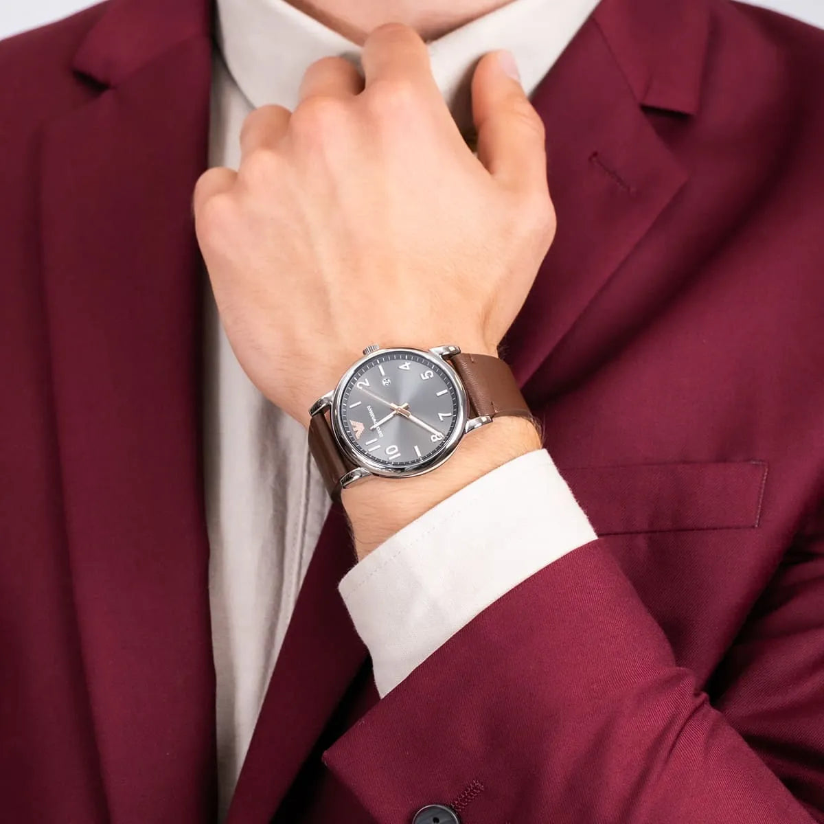 Emporio Armani Luigi watch worn on wrist with gray dial visible on brown leather strap
