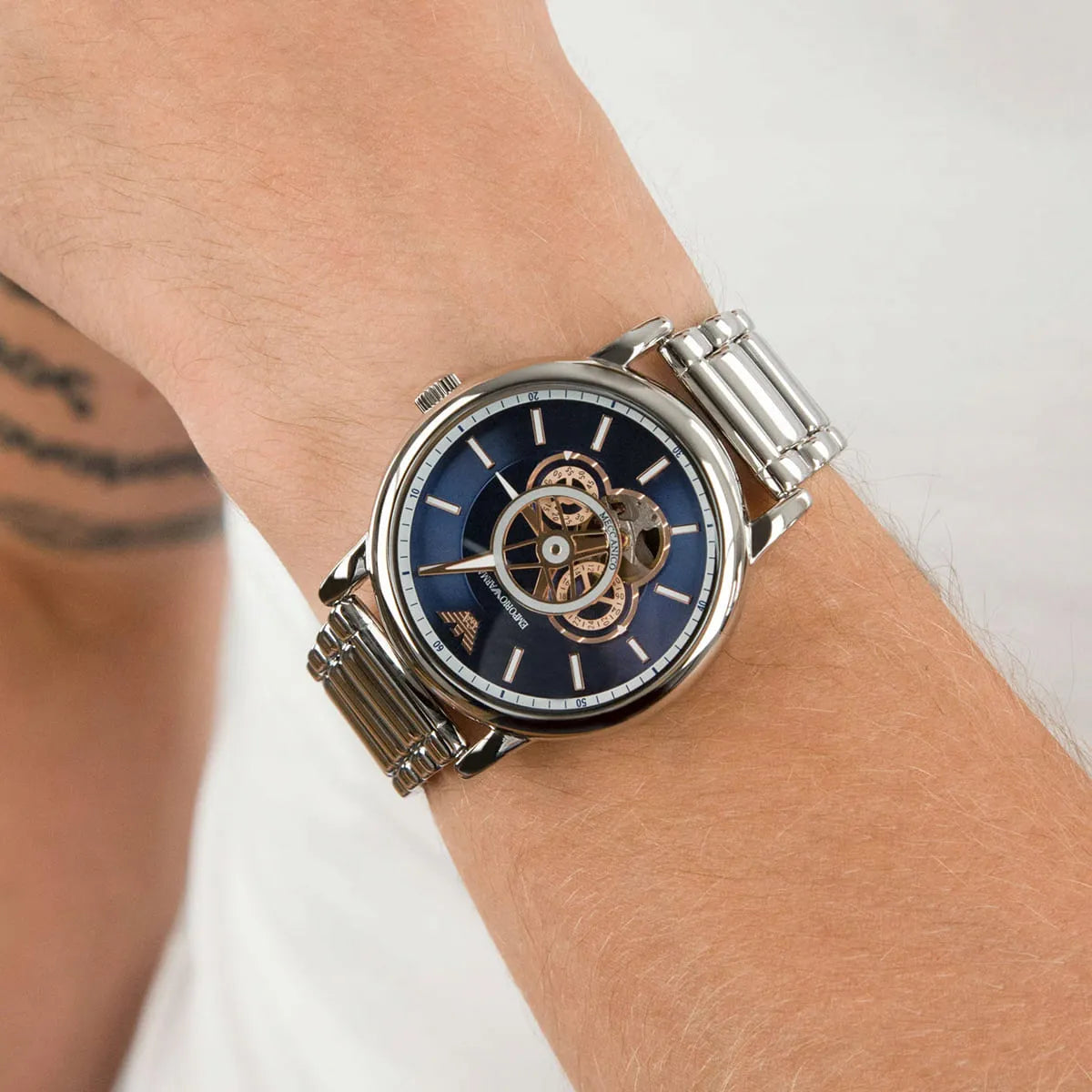 Luigi chronograph watch on wrist showing skeleton dial with rose gold movement and silver bracelet