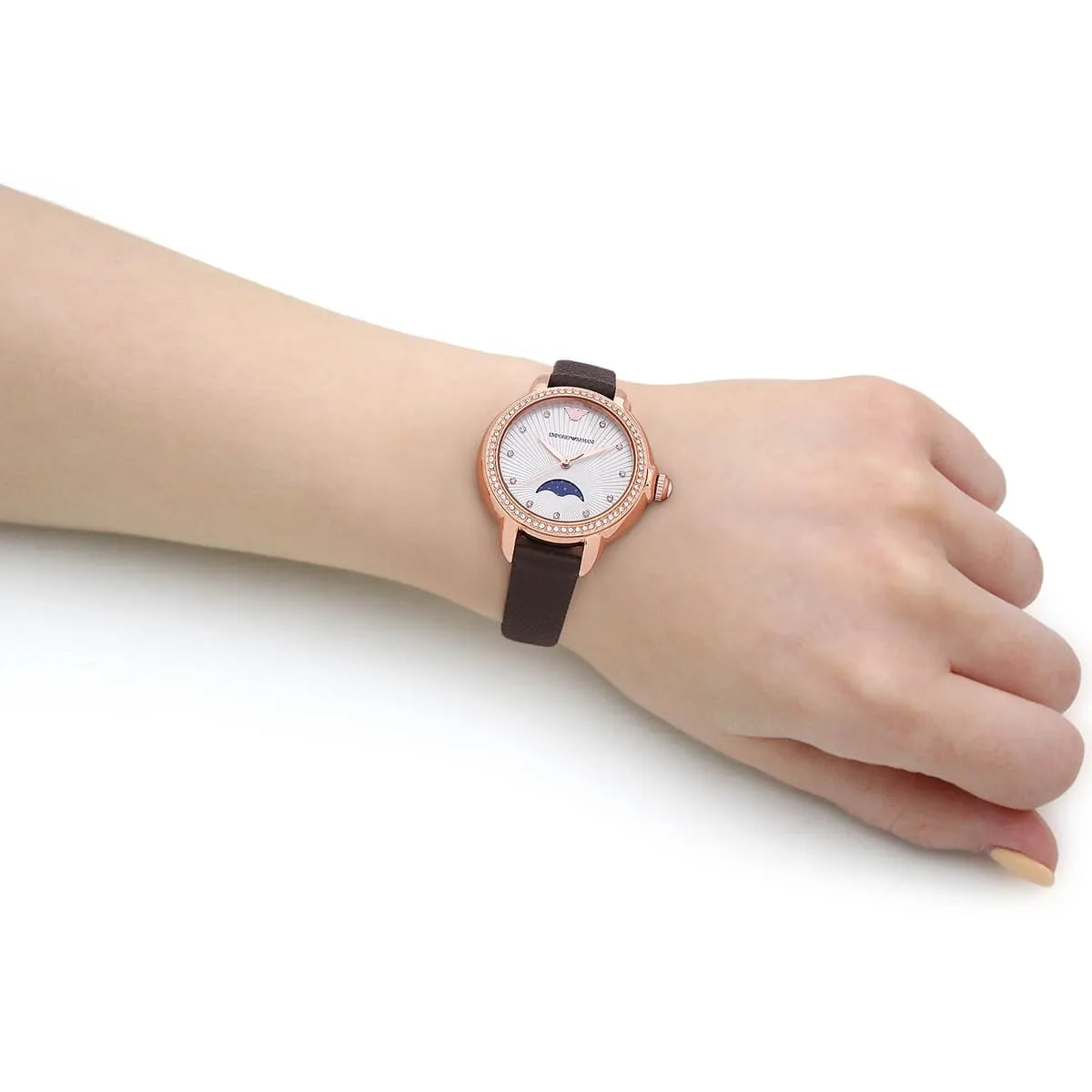 Emporio Armani Mia quartz watch on wrist displaying silver dial, moonphase complication, and brown leather strap