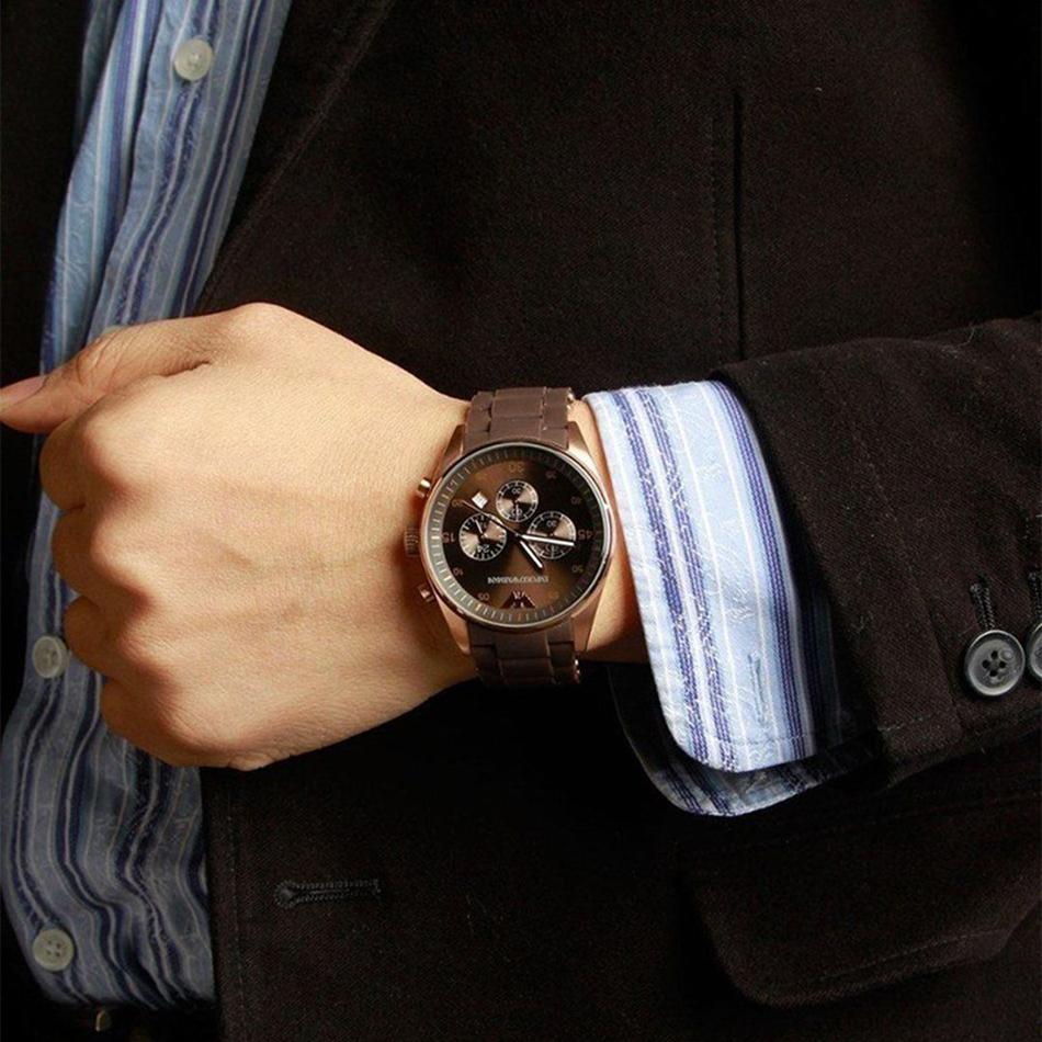Men's wrist wearing Emporio Armani Sport Chronograph with brown dial and rose gold case