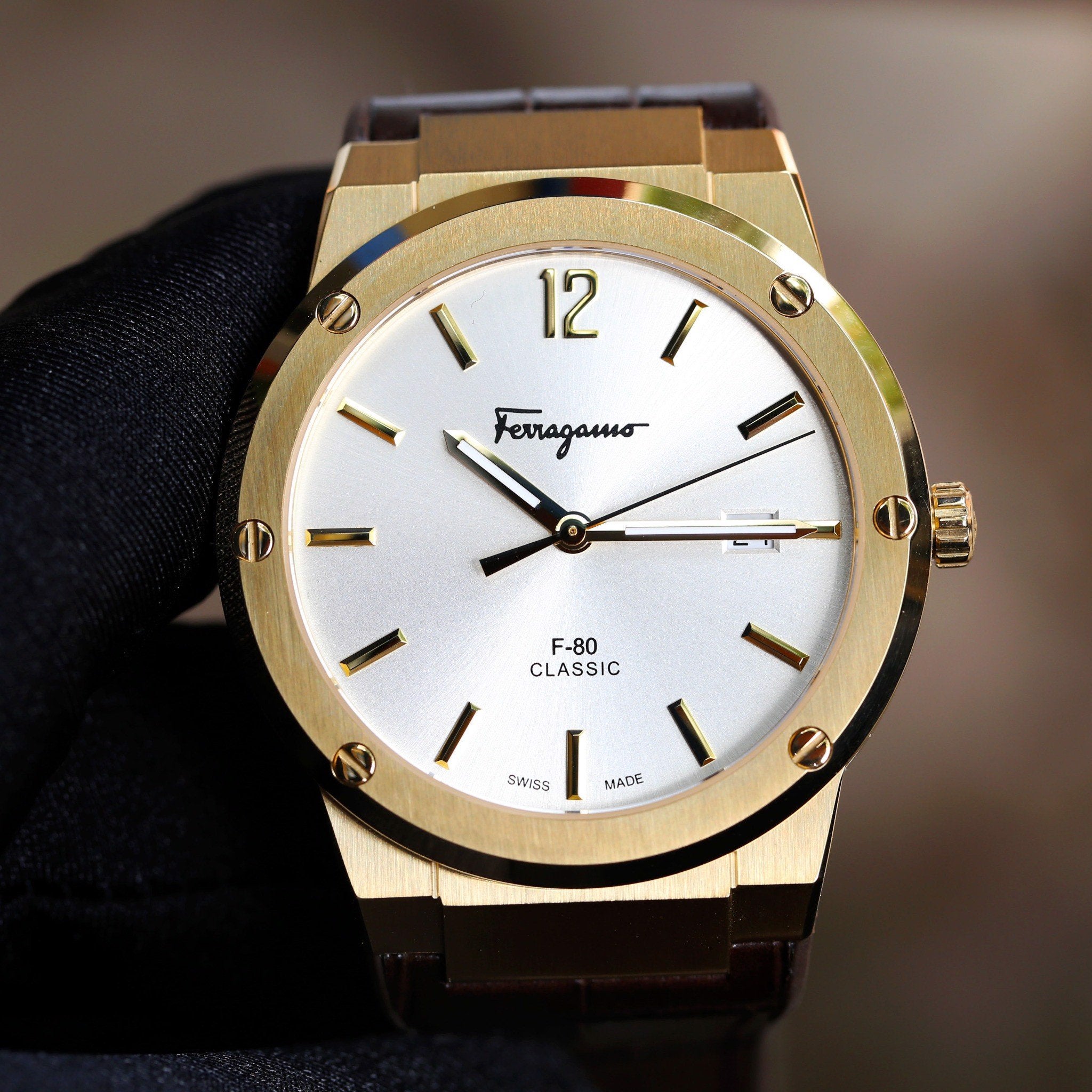 Ferragamo F-80 Classic watch front view with gold case, white dial, and steel bracelet