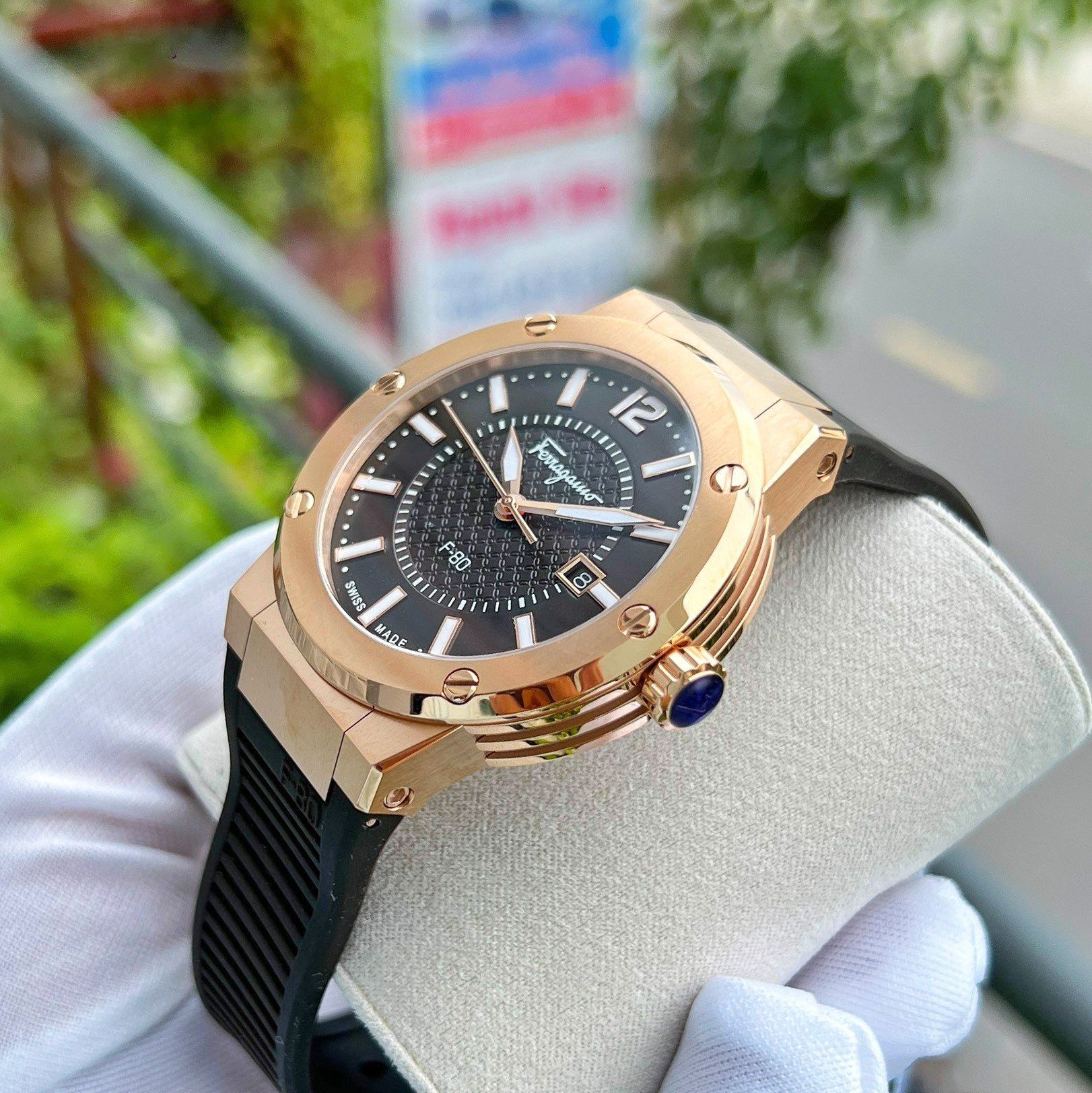 Three-quarter view of Ferragamo F-80 men's watch with rose gold case and brown dial