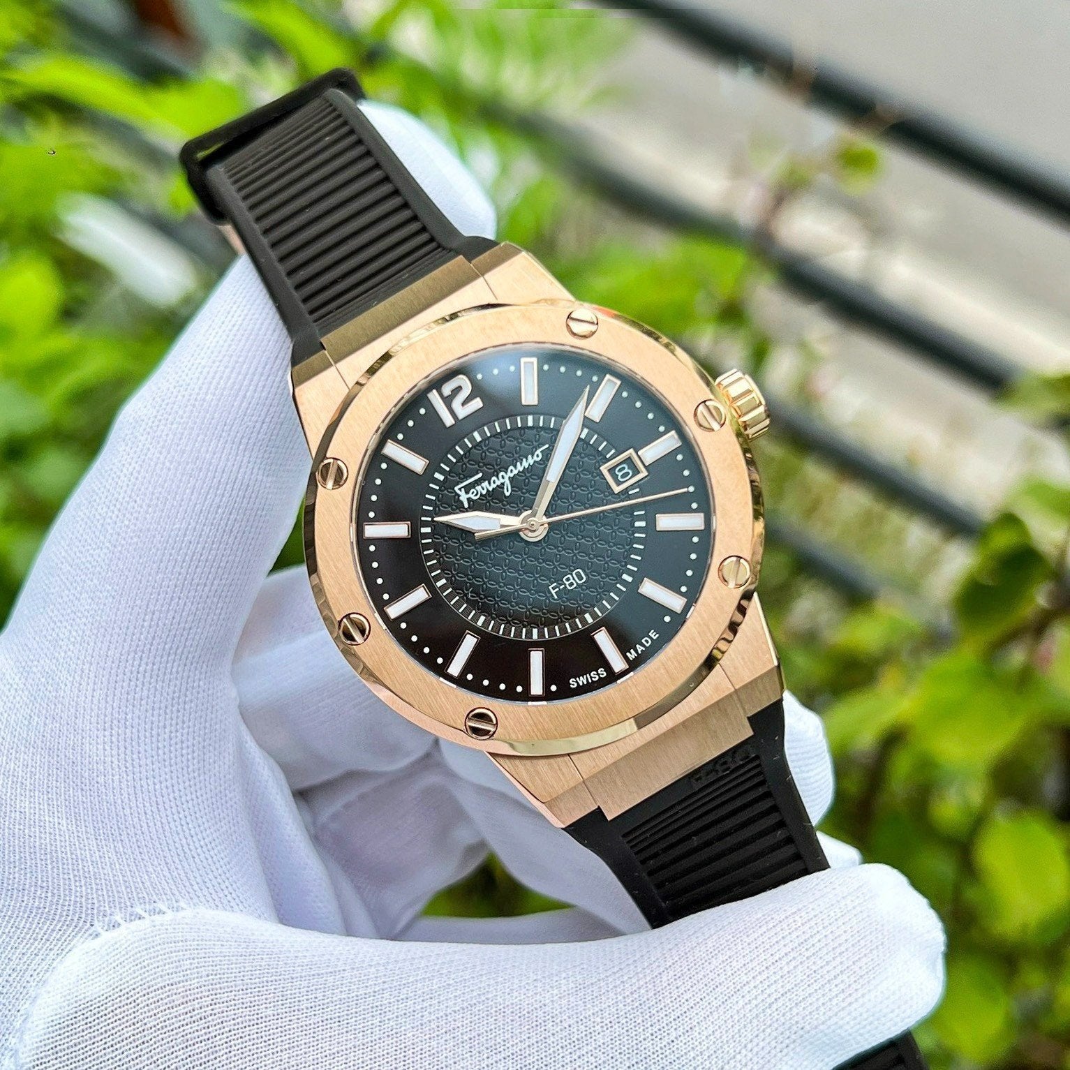 Ferragamo F-80 Swiss made watch worn on wrist showing brown dial and rose gold case