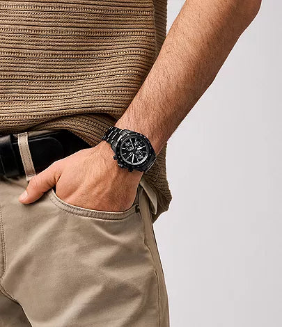 Fossil Autocross black chronograph watch worn on wrist with black stainless steel bracelet