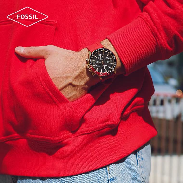 Fossil Bannon watch worn on wrist with black chronograph dial and red strap