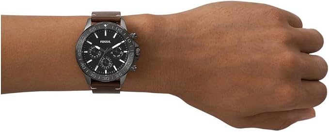Fossil Bannon multifunction watch worn on wrist showing black dial and brown leather strap