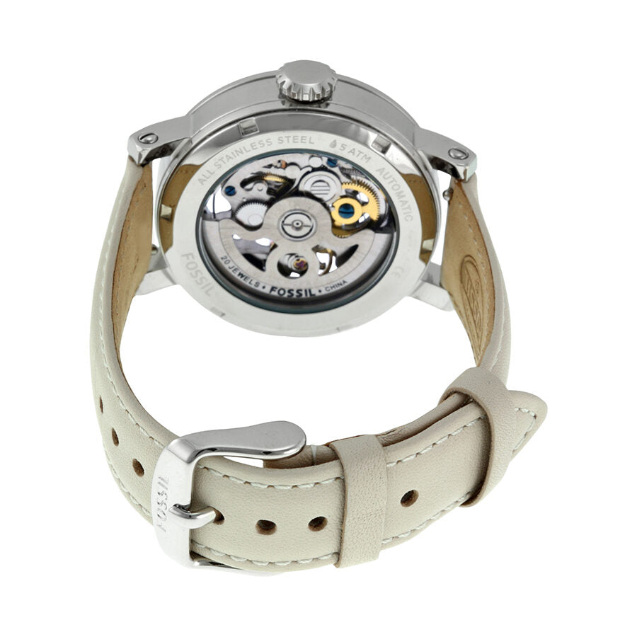 Caseback view of Fossil Boyfriend automatic watch displaying mechanical movement with cream strap