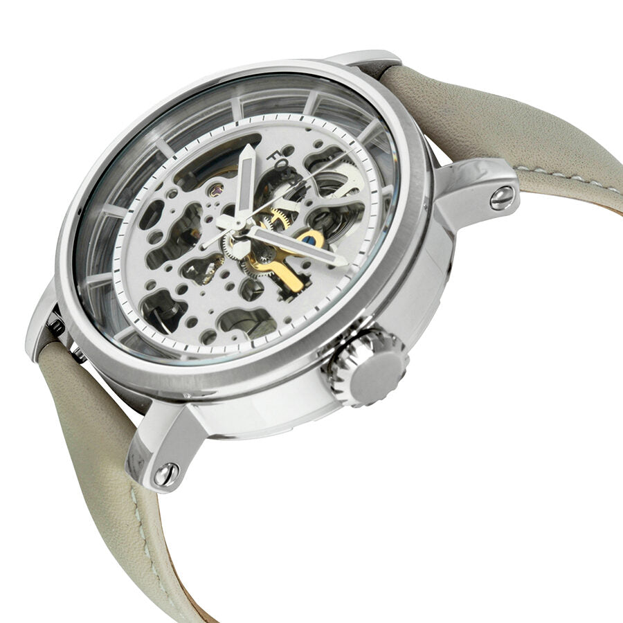 Angled view of Fossil Boyfriend skeleton dial watch with cream strap showcasing transparent dial