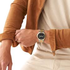 Fossil BQ2752 two-tone chronograph watch worn on wrist with brown leather jacket