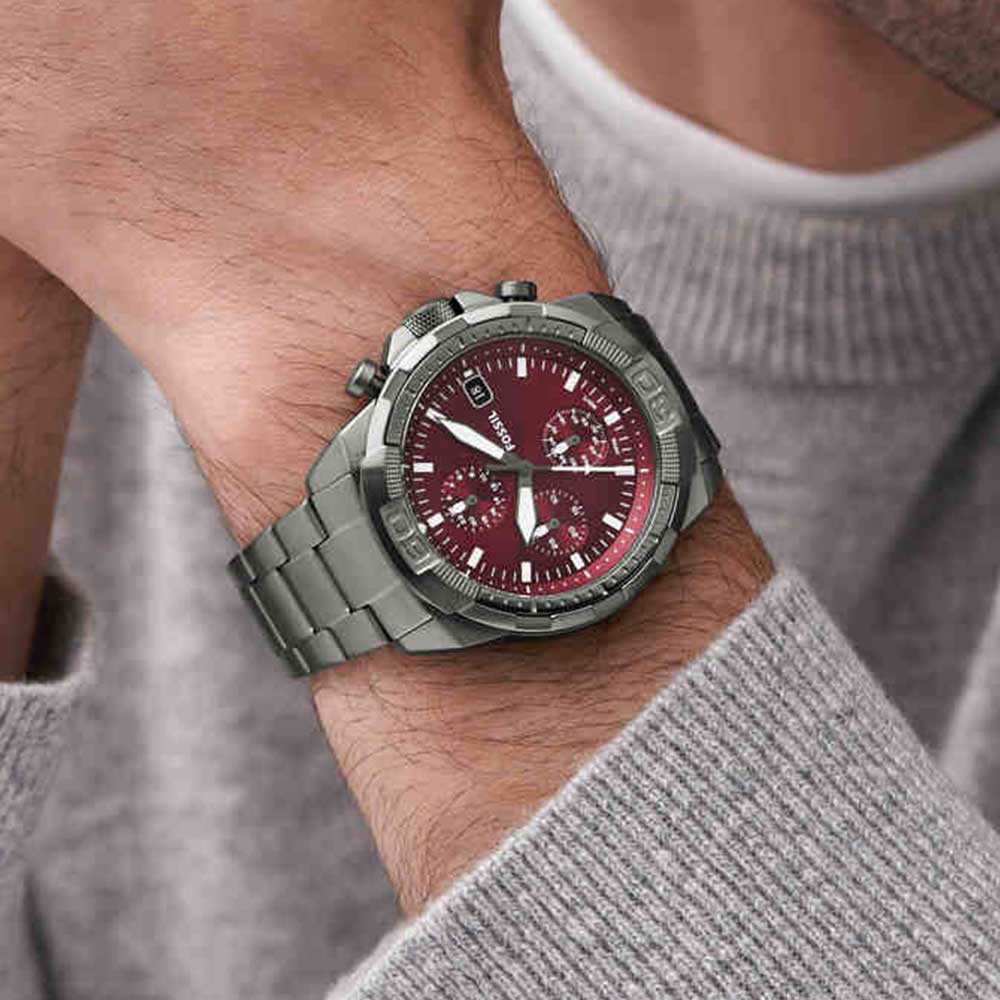Fossil Bronson chronograph watch on wrist displaying burgundy dial and smoke finish