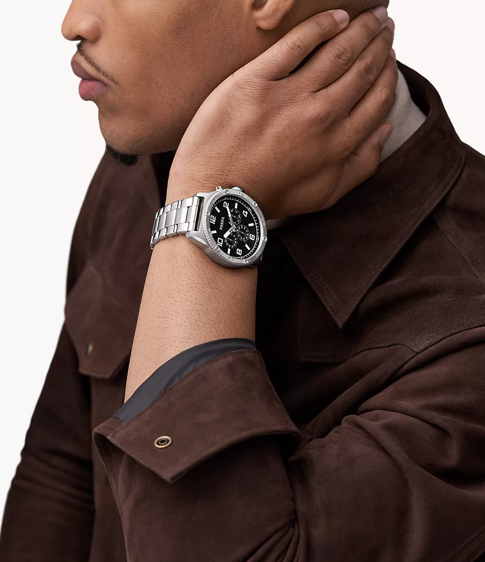 Fossil Brox black dial chronograph watch worn on wrist with silver steel bracelet