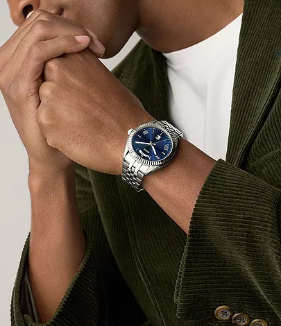 Campbell stainless steel watch worn on wrist with blue dial visible