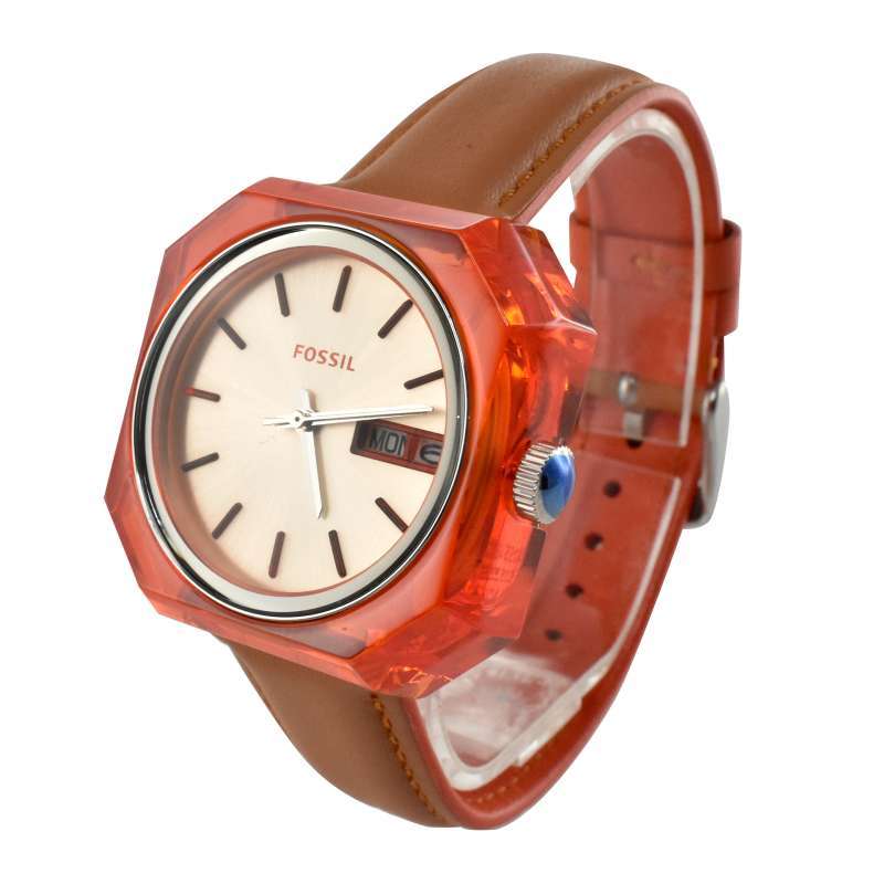 Fossil Candy ES3537 watch shown at angle displaying orange resin case and brown leather strap
