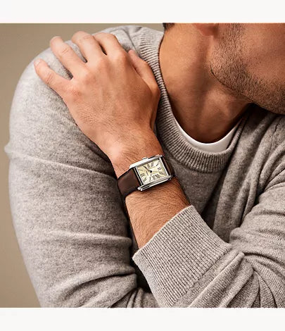 Fossil Carraway FS6012 brown leather watch worn on wrist with beige sweater