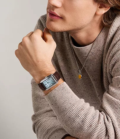 Fossil Carraway watch worn on wrist with brown leather strap and light blue dial visible