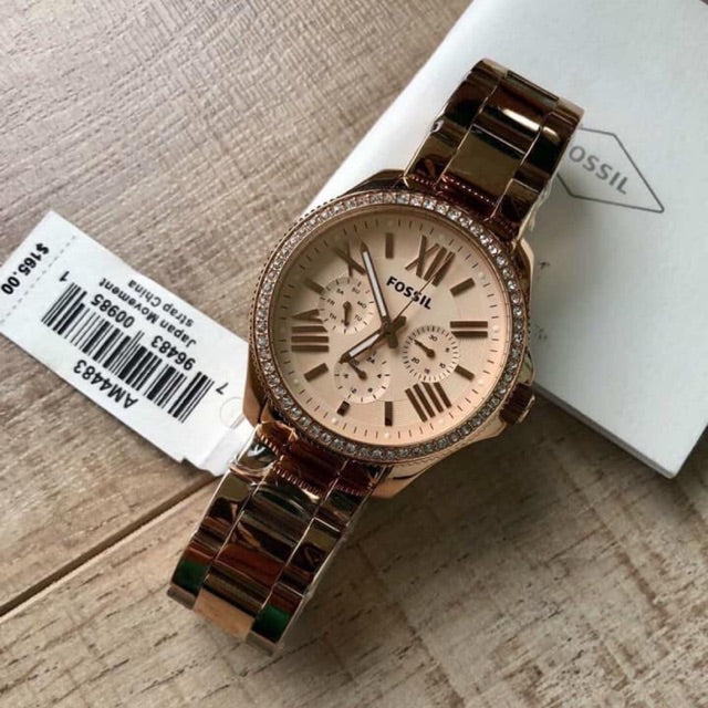 Fossil Cecile rose gold multifunction watch on wrist next to product box