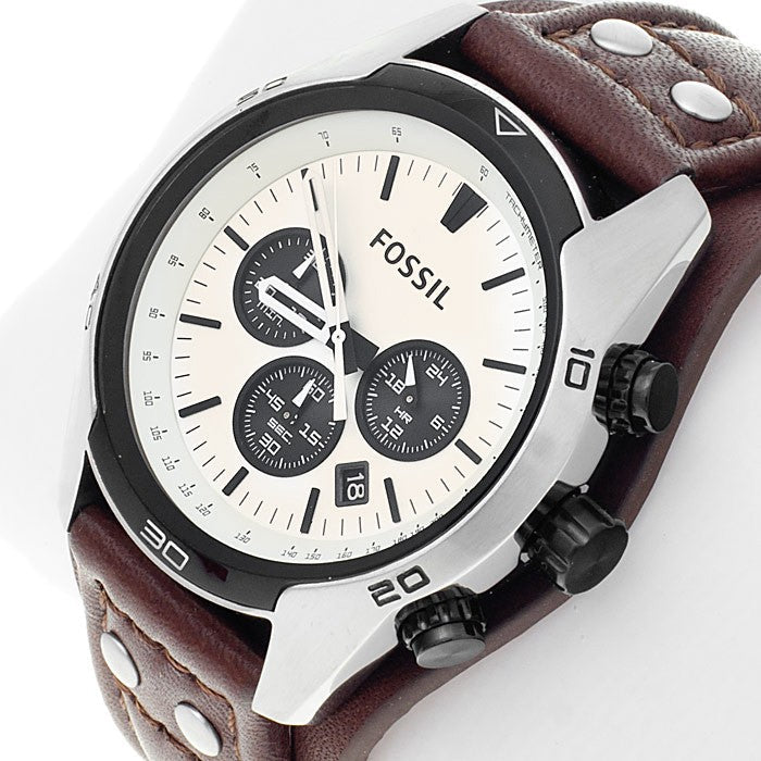Fossil Coachman CH2890 watch angled view showing white chronograph dial and brown leather band
