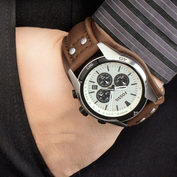 Fossil Coachman CH2890 watch on wrist with formal attire showing chronograph dial