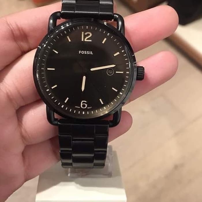 Fossil Commuter FS5277 black dial watch held in hand showing dial detail
