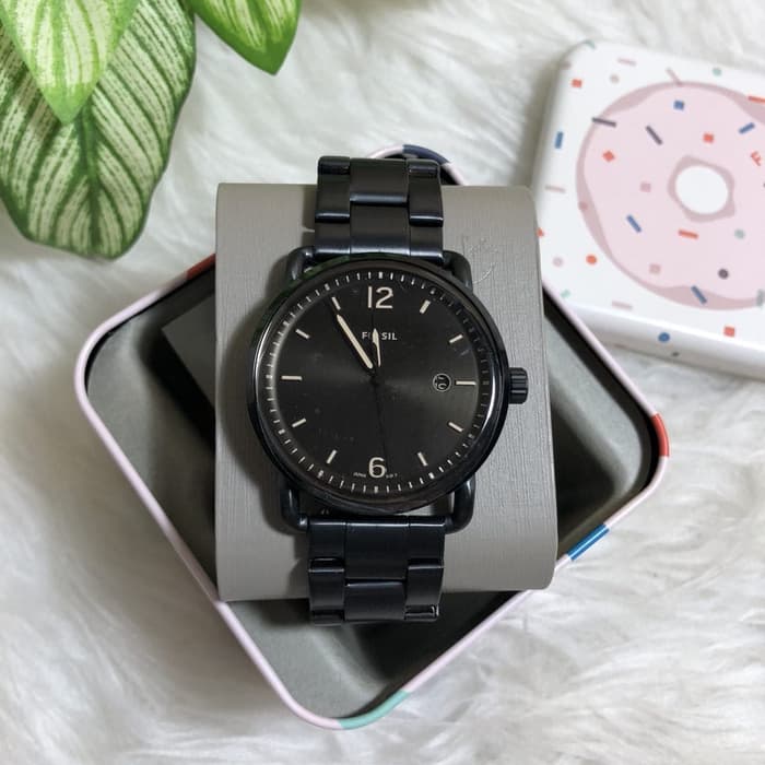 Fossil Commuter FS5277 watch on display with plant and accessories