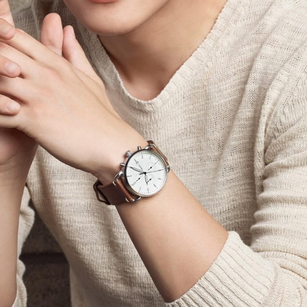 Fossil Commuter chronograph watch worn on wrist with cream dial and brown strap